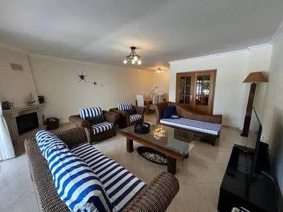 a living room with couches and a coffee table at Paradise Beach Villa in Albufeira