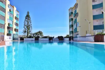 a large swimming pool in front of some apartment buildings at Amendoeiras II - Central Vilamoura in Vilamoura