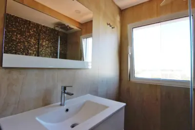 a bathroom with a sink and a mirror at Amendoeiras II - Central Vilamoura in Vilamoura