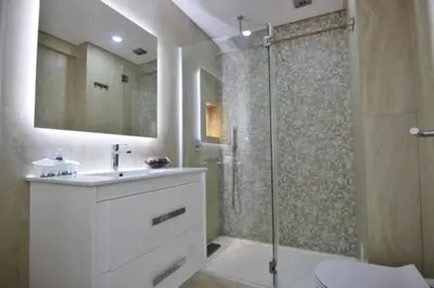 a bathroom with a shower and a toilet and a sink at Amendoeiras II - Central Vilamoura in Vilamoura