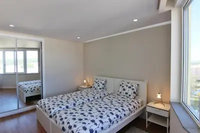 a bedroom with a bed and a large window at Amendoeiras II - Central Vilamoura in Vilamoura