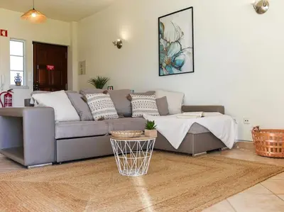 a living room with a couch and a table at Joia da Galé House by Stay ici Algarve Holiday Rental in Albufeira