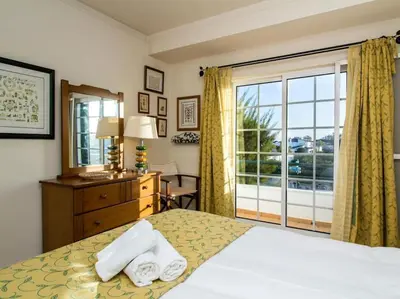 a bedroom with a bed with two towels on it at Joia da Galé House by Stay ici Algarve Holiday Rental in Albufeira