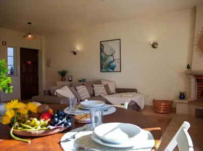 a living room with a table and a couch at Joia da Galé House by Stay ici Algarve Holiday Rental in Albufeira
