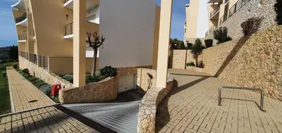 a walkway next to a building with a wall at Apartamento Costa in Albufeira