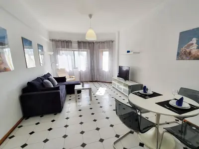 a living room with a couch and a table at Solaris- Familiar, Wifi, Totalmente Equipado in Quarteira
