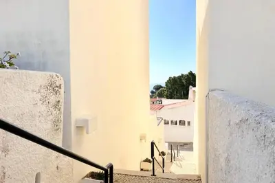 a view from the stairs of a white building at Albufeira Jardim l old town and beach - Hawai in Albufeira