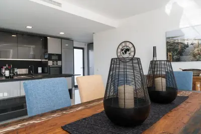 a kitchen and dining room with two bird cages on a table at Colinas do Golfe Vilamoura Sun by SAPvillas in Vilamoura