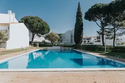 a swimming pool in the middle of a building at Soleil Apartment in Quarteira