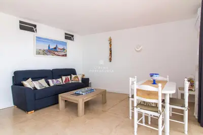 a living room with a blue couch and a table at Apartment Aveiros Beach- D´Alma Amado in Albufeira