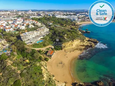 an aerial view of the beach with the ocean safe sign at Apartment Aveiros Beach- D´Alma Amado in Albufeira