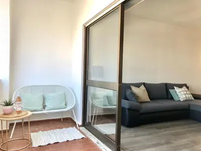 a living room with a couch and a chair at Albufeira I old town and city center in Albufeira