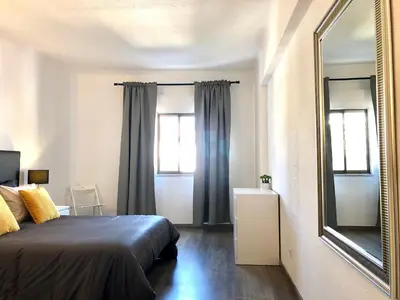 a bedroom with a bed and a mirror at Albufeira I old town and city center in Albufeira