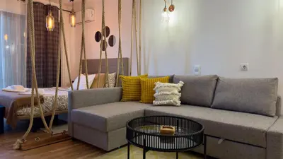 a living room with a couch and a table at Cozy and Stylish Studio Apt - just 800m from the beach in Albufeira