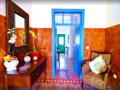 a room with a mirror and a table and a chair at Elegant villa with sea view in Loulé + private pool in Loulé