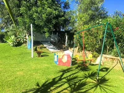 a playground in a yard with a swing at Elegant villa with sea view in Loulé + private pool in Loulé