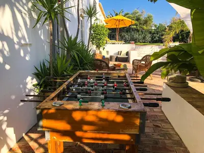 a wooden foosball table in the middle of a patio at Elegant villa with sea view in Loulé + private pool in Loulé