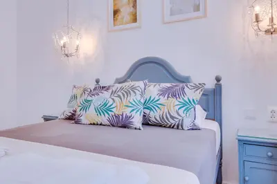 a bed with two pillows on it in a bedroom at Groundfloor in Faro