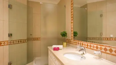 a bathroom with a sink and a mirror at Joanne in Vale do Lobo