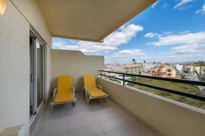 two chairs on a balcony with a view of the city at AL - Maré in Albufeira