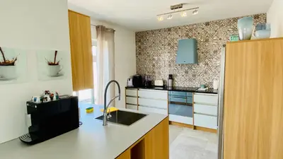 a kitchen with a sink and a counter top at Otto by Check-in Portugal in Quarteira