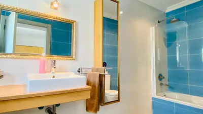 a bathroom with a sink and a mirror and a toilet at Otto by Check-in Portugal in Quarteira