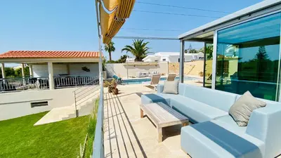 a living room with a blue couch and a house at Otto by Check-in Portugal in Quarteira