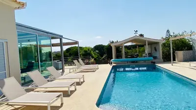 a swimming pool with lounge chairs and a swimming pool at Otto by Check-in Portugal in Quarteira