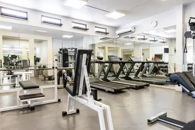 a gym with rows of treadmills and mirrors at Apartament Portes Balaia Golf Resort in Albufeira