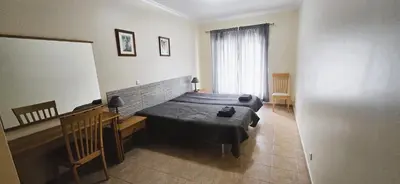 a bedroom with a large bed in a room at Open Space - Albufeira in Albufeira