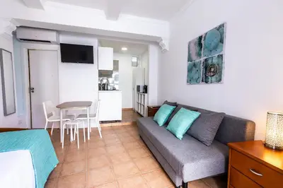 a living room with a couch and a table at Faro Downtown Ria Formosa I in Faro
