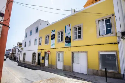 a yellow building on the side of a street at Faro Downtown Ria Formosa I in Faro