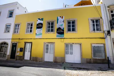 a yellow building with signs on the side of it at Faro Downtown Ria Formosa I in Faro