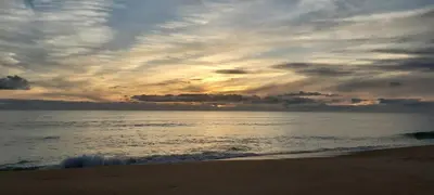 a sunset on the beach with the ocean at Casa Senhora da Ria- localização perfeita em Faro in Faro