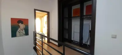 a room with a mirror and a painting on a wall at Casa Senhora da Ria- localização perfeita em Faro in Faro