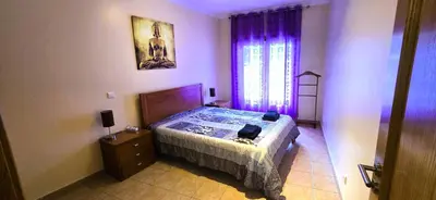 a bedroom with a bed and a dresser and a window at Odete Túnel - Albufeira in Albufeira
