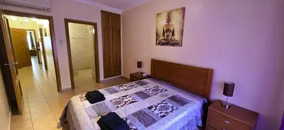 a bedroom with a bed with a quilt on it at Odete Túnel - Albufeira in Albufeira