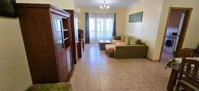 a living room with a couch and a table at Odete Túnel - Albufeira in Albufeira