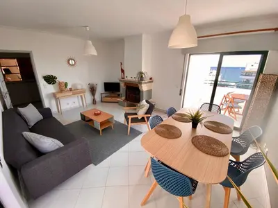 a living room with a table and a couch at CosyAvenida Mar, 2 rooms in Quarteira