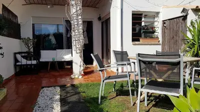 a patio with a table and chairs in a house at Cozy Garden T1 near the beach in Albufeira