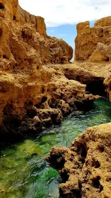 a body of water in a canyon with rocks at Cozy Garden T1 near the beach in Albufeira
