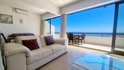 a living room with a couch and a view of the ocean at Albufeira, Sea View (25) in Albufeira