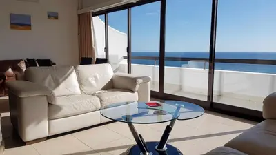 a living room with a couch and a glass table at Albufeira, Sea View (25) in Albufeira