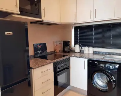 a kitchen with a washer and a dishwasher in it at Albufeira, Sea View (25) in Albufeira