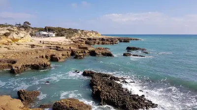 a beach with rocks in the water and the ocean at Albufeira, Sea View (25) in Albufeira
