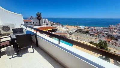 a balcony with two chairs and a view of the ocean at Albufeira, Sea View (25) in Albufeira