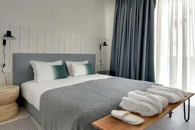 a bedroom with a bed with towels on a table at Villa Ocean Marina, Panoramic and heatable Pool by DreamvillasAlbufeira in Albufeira