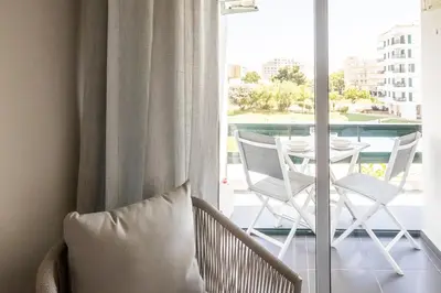 a room with a balcony with a table and chairs at Aldeia do Mar Studio Vilamoura Center - SWIMMING POOL in Vilamoura