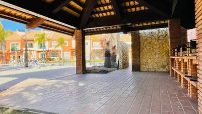 a pavilion with a stone wall and a building at Santa Maria N by Check-in Portugal in Albufeira