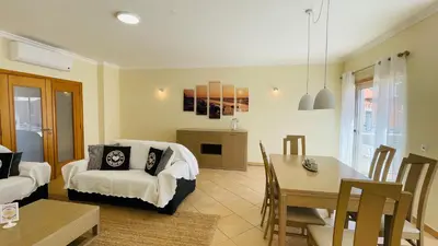 a living room with a table and a dining room at Santa Maria N by Check-in Portugal in Albufeira